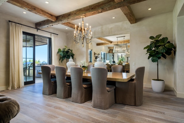 dining space with a chandelier, light wood finished floors, beamed ceiling, and baseboards