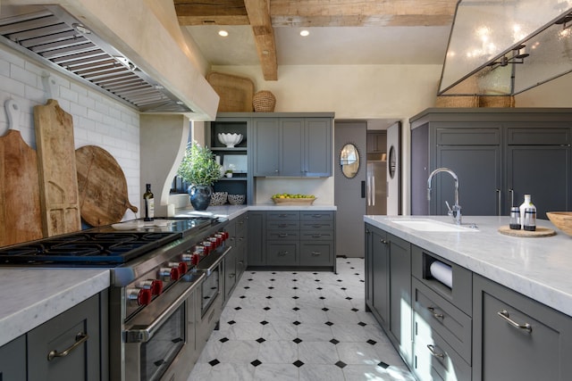 kitchen featuring open shelves, gray cabinetry, a sink, double oven range, and premium range hood