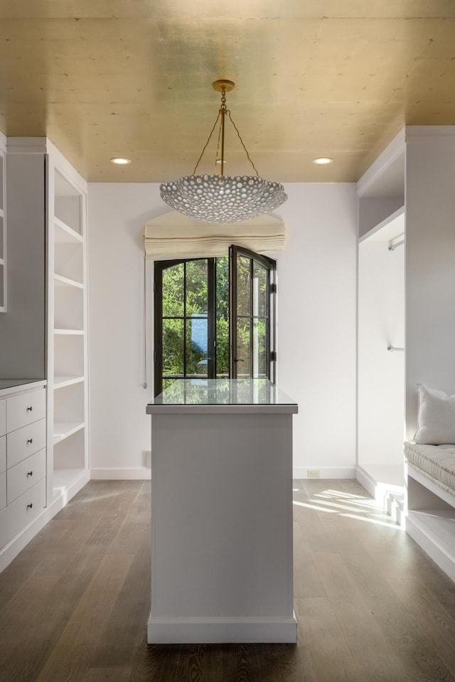 interior space featuring dark wood-style floors, recessed lighting, baseboards, and decorative light fixtures