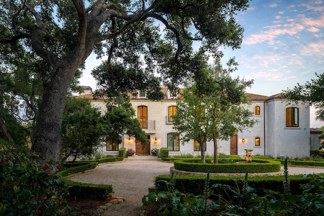 mediterranean / spanish-style home with driveway and stucco siding