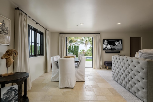 dining room with baseboards, stone tile flooring, and recessed lighting