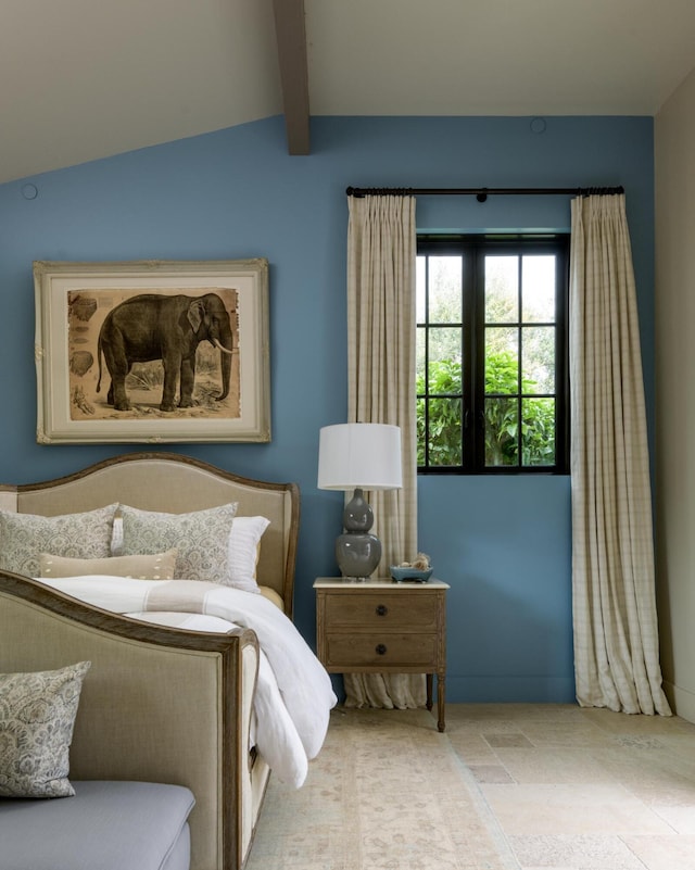 bedroom with lofted ceiling with beams