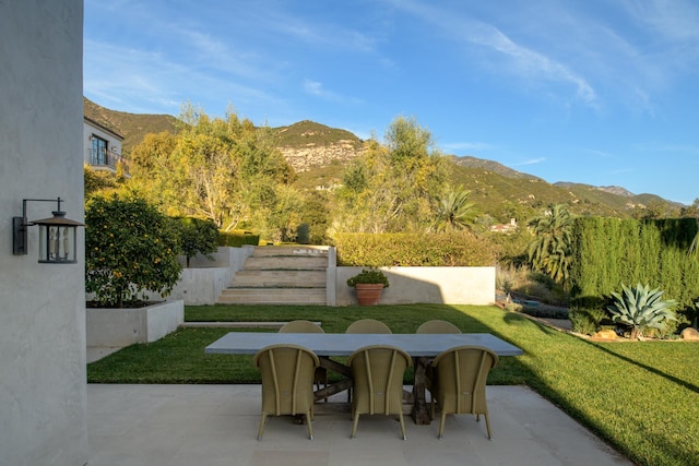 exterior space with outdoor dining space and a mountain view