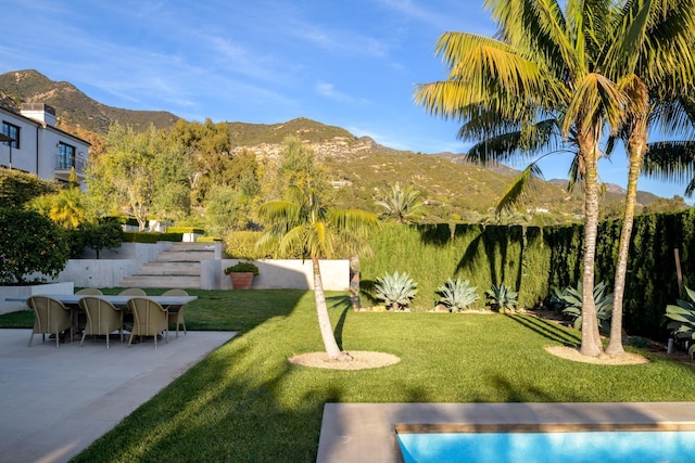 view of yard with a patio area and a mountain view