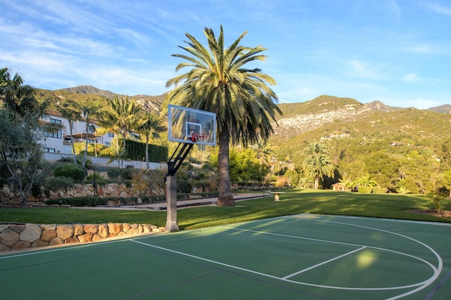 view of sport court with community basketball court, a yard, and a mountain view