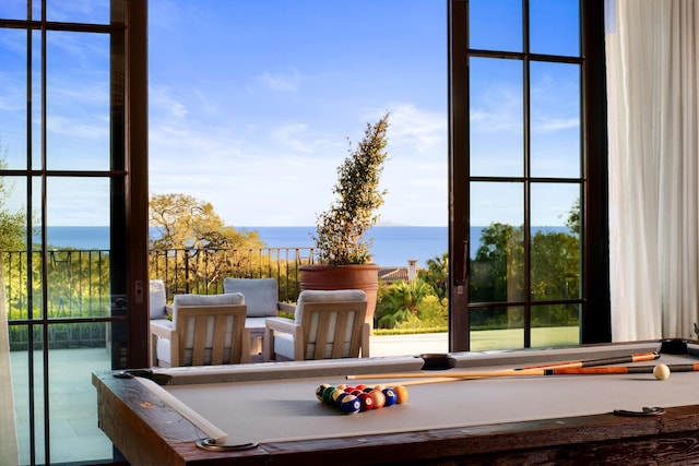 game room with a water view and billiards