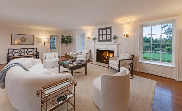 living room with ornamental molding and wood-type flooring