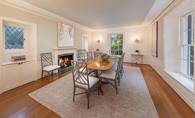 dining space with crown molding and hardwood / wood-style flooring