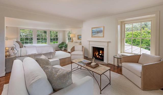 living room featuring crown molding, a healthy amount of sunlight, and hardwood / wood-style flooring