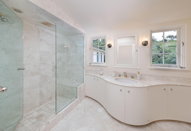 bathroom featuring vanity and tiled shower