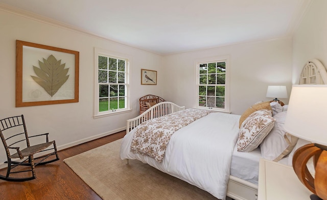 bedroom featuring multiple windows, crown molding, and dark hardwood / wood-style floors