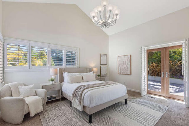 bedroom with a chandelier, light carpet, access to exterior, and multiple windows