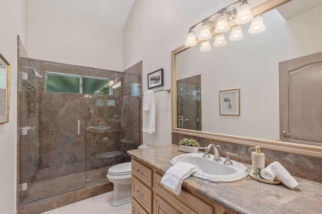 bathroom with a shower stall, tile patterned flooring, vanity, and toilet