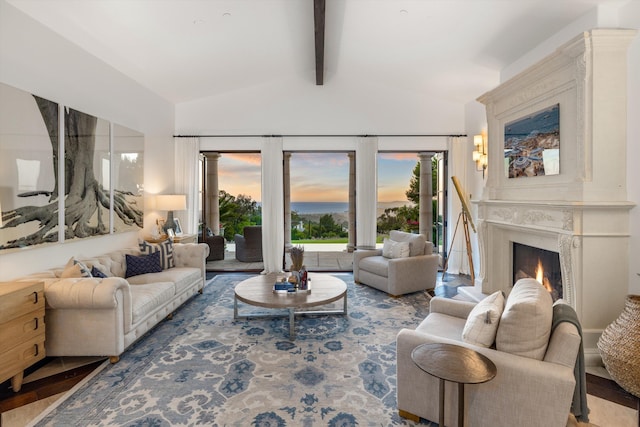 living room featuring a fireplace, beam ceiling, and high vaulted ceiling