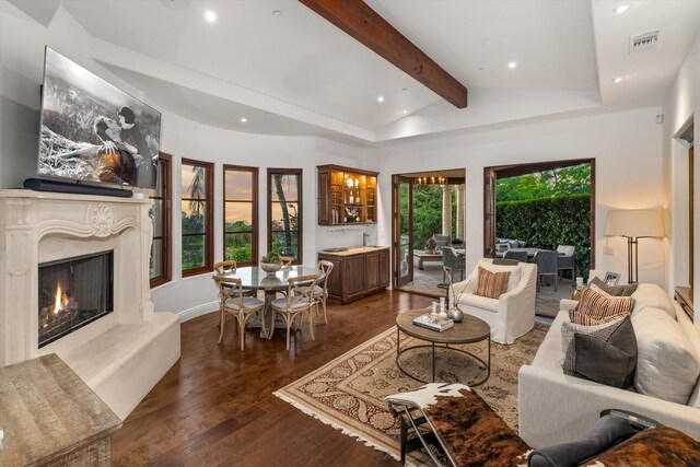 living room featuring a high end fireplace, beamed ceiling, high vaulted ceiling, and dark wood-type flooring