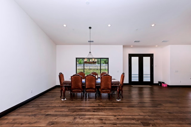 dining area featuring a notable chandelier and dark hardwood / wood-style flooring