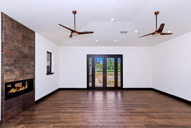 unfurnished living room with a fireplace, dark hardwood / wood-style flooring, ceiling fan, and lofted ceiling