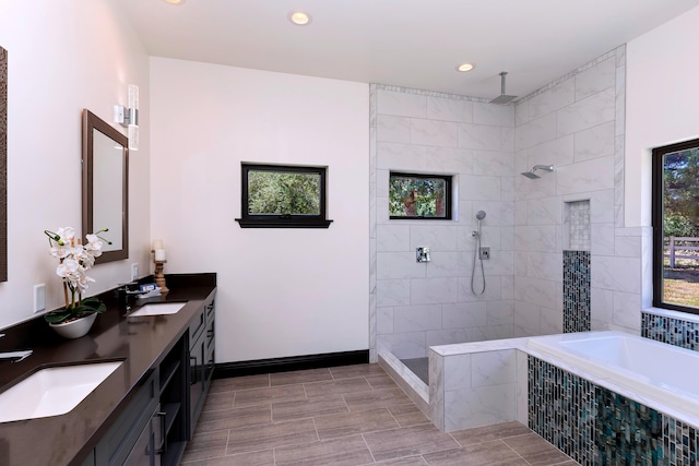 bathroom featuring vanity, plenty of natural light, and independent shower and bath