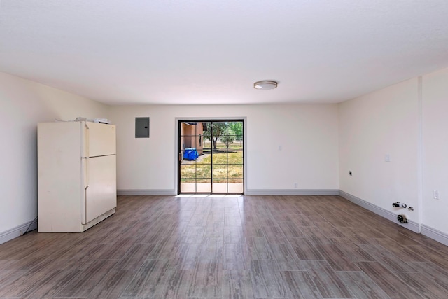 empty room featuring wood-type flooring and electric panel