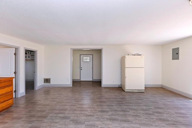 interior space with electric panel and heating unit