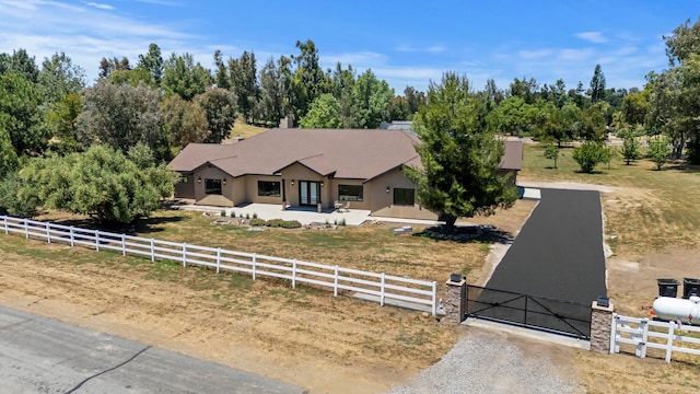 view of front of home with a rural view