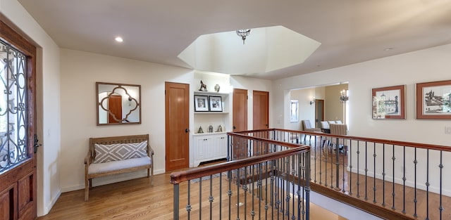 corridor with light hardwood / wood-style floors and a wealth of natural light