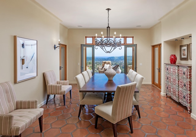 dining room with plenty of natural light, a chandelier, a mountain view, and dark tile flooring