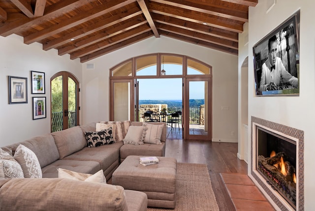 living room with beamed ceiling, high vaulted ceiling, and hardwood / wood-style flooring