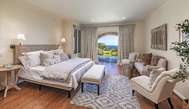 bedroom with hardwood / wood-style flooring and access to exterior