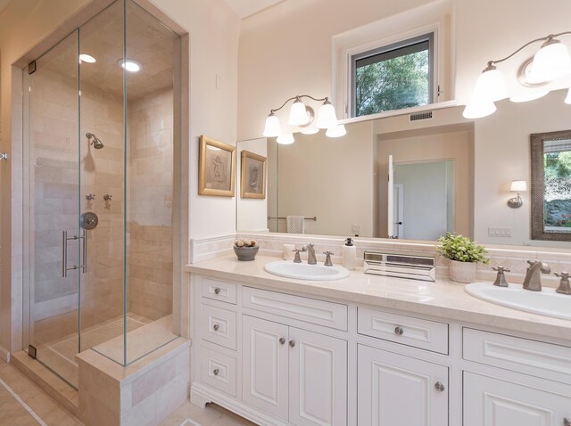 bathroom featuring dual sinks, an enclosed shower, backsplash, and large vanity