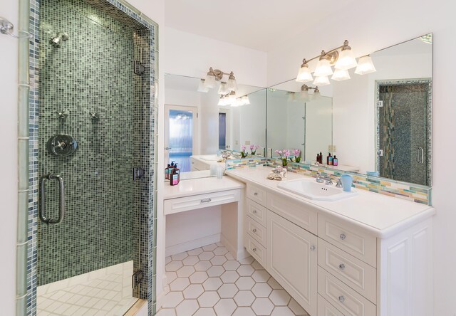 bathroom with tile floors, a shower with shower door, and vanity