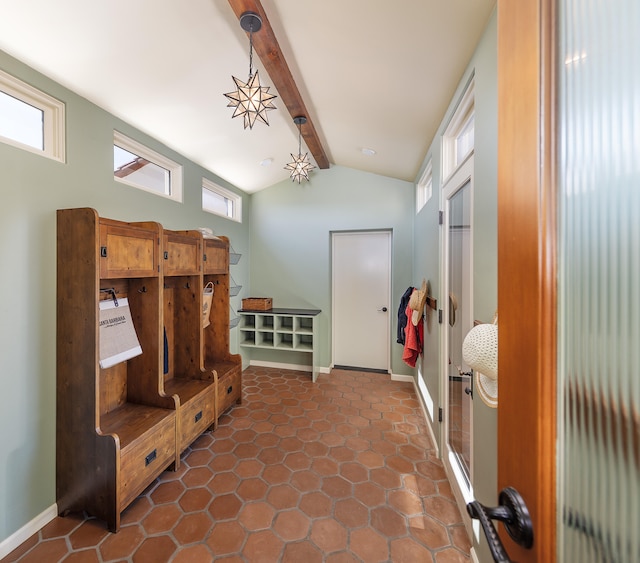 mudroom featuring lofted ceiling with beams and dark tile flooring