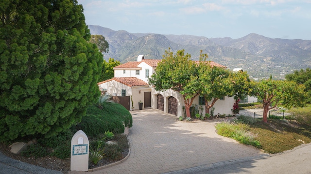 view of front of home featuring a mountain view and a garage