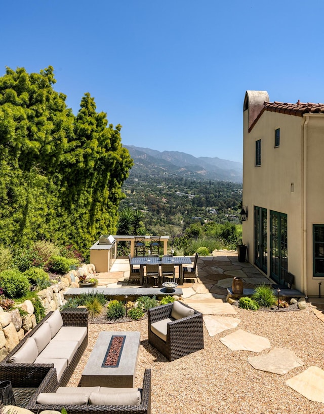 view of patio / terrace with a mountain view and an outdoor living space