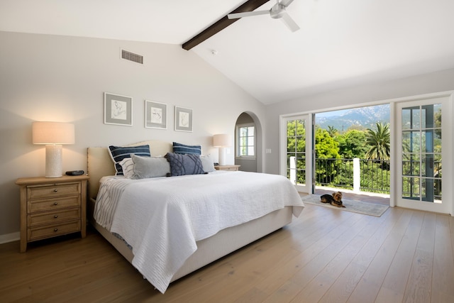 bedroom with vaulted ceiling with beams, ceiling fan, access to exterior, and hardwood / wood-style flooring