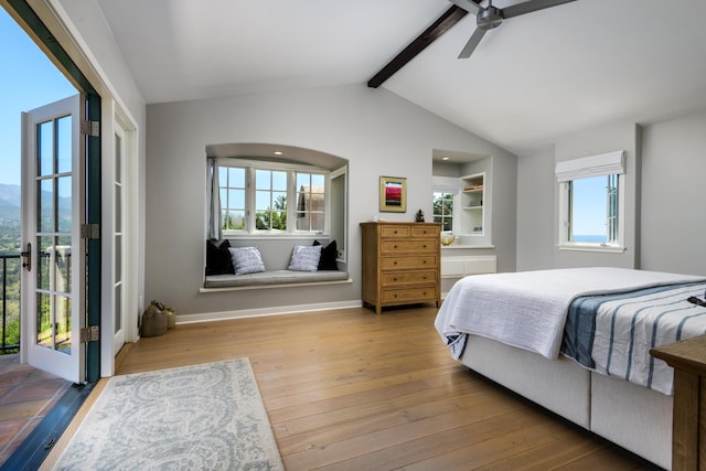 bedroom featuring hardwood / wood-style floors, ceiling fan, and vaulted ceiling with beams