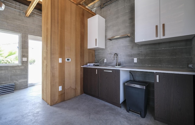 kitchen featuring white cabinetry and sink