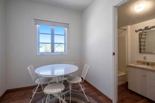 dining area with sink and dark hardwood / wood-style floors