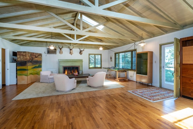 unfurnished living room with beamed ceiling, hardwood / wood-style floors, and high vaulted ceiling