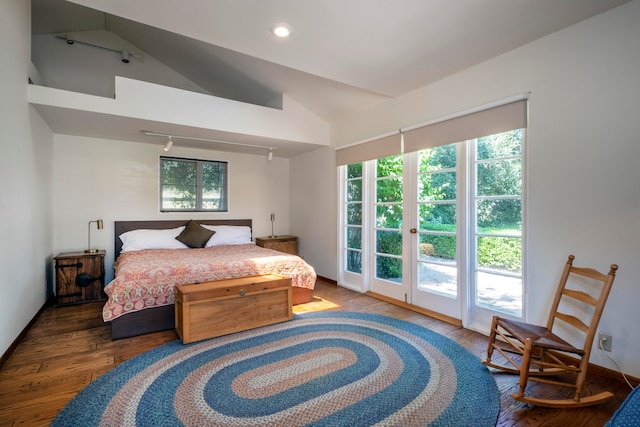 bedroom with vaulted ceiling, hardwood / wood-style flooring, and access to exterior