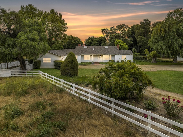 single story home with a yard