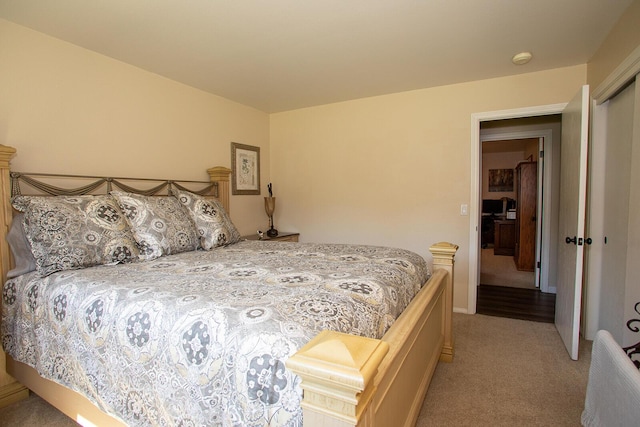 bedroom featuring light colored carpet and a closet