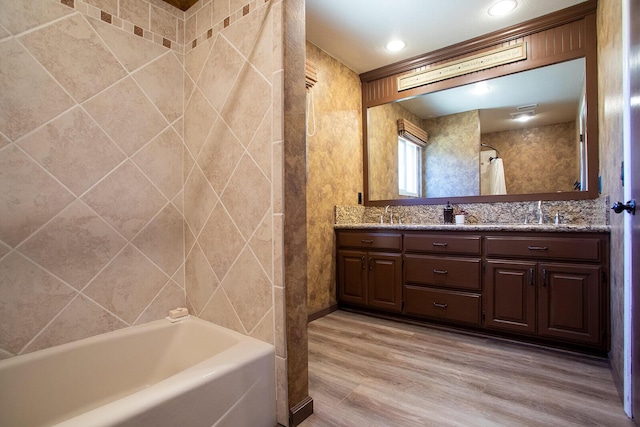 bathroom featuring hardwood / wood-style floors, vanity, and shower / bath combo with shower curtain