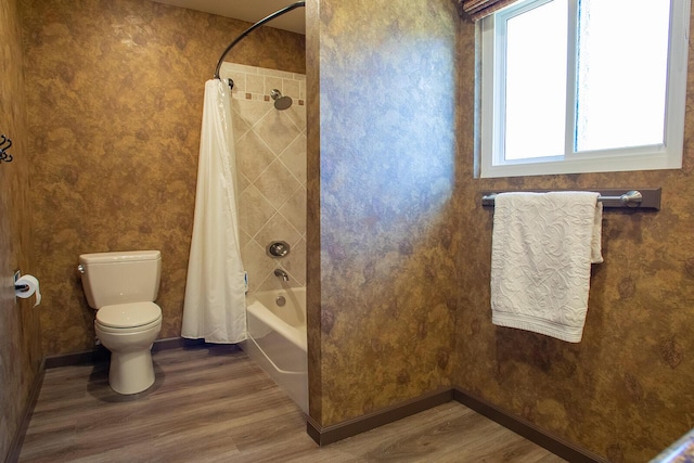 bathroom with shower / bath combo, toilet, and hardwood / wood-style floors