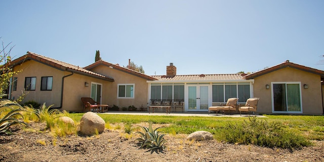 back of property featuring french doors and a patio