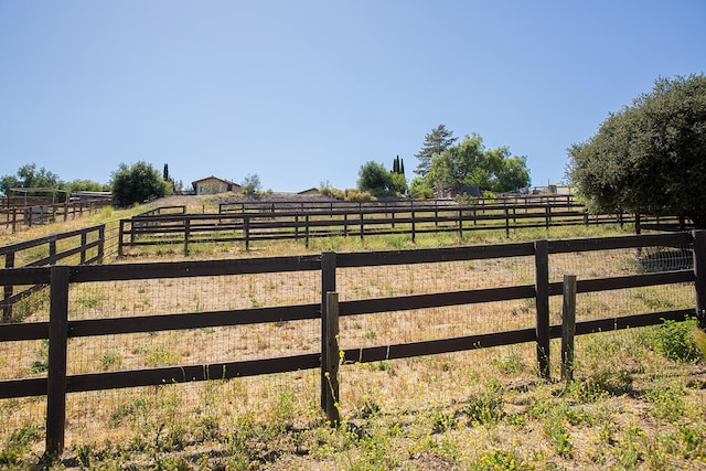 view of gate with a rural view