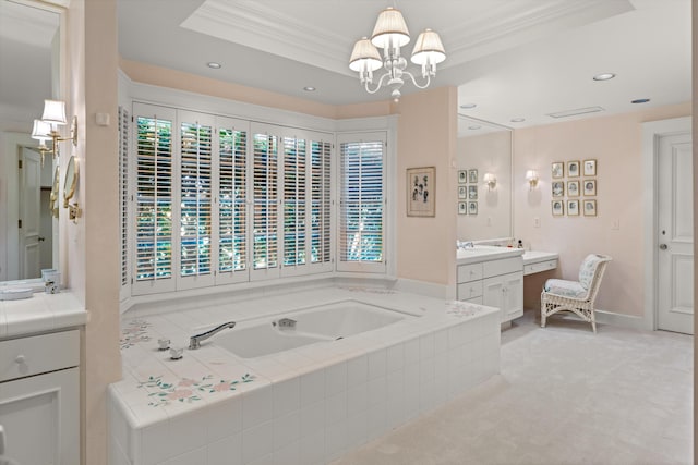 bathroom featuring a notable chandelier, crown molding, vanity, a relaxing tiled tub, and a raised ceiling