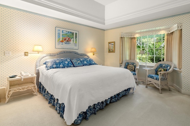 carpeted bedroom featuring crown molding and a tray ceiling