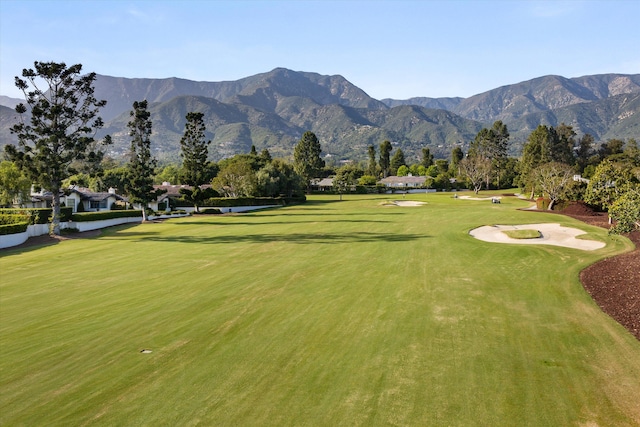 view of home's community featuring a mountain view and a lawn