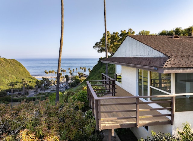 wooden terrace featuring a water view